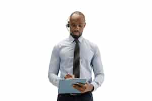 Free photo young african-american call center consultant with headset isolated on white studio