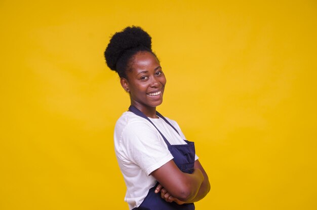 Young African-American female posing on yellow