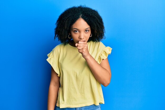 Young african american girl wearing casual clothes feeling unwell and coughing as symptom for cold or bronchitis health care concept