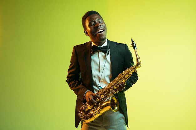 Young african-american jazz musician playing the saxophone