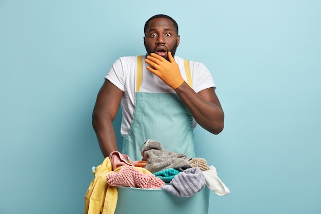 Young African American man doing laundry