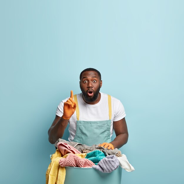 Young African American man doing laundry