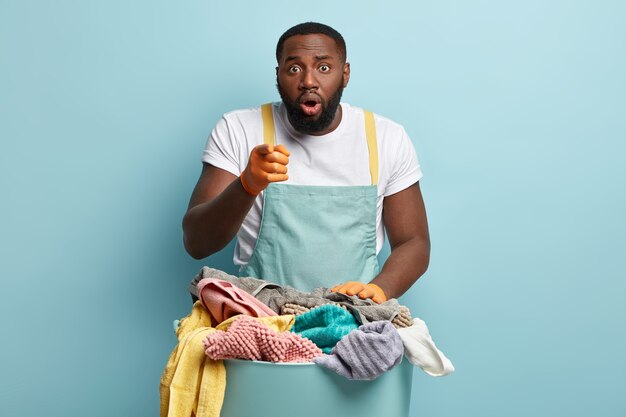 Young African American man doing laundry