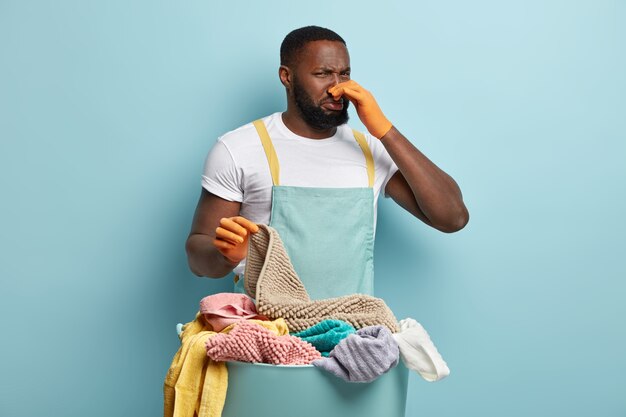 Young African American man doing laundry