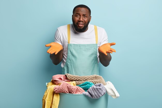 Young African American man doing laundry