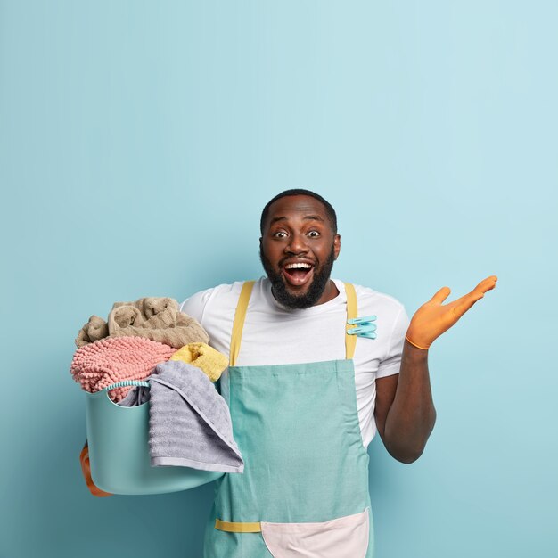 Young African American man doing laundry