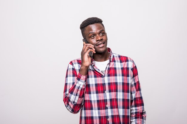 Young African American man holding his phone isolated on white