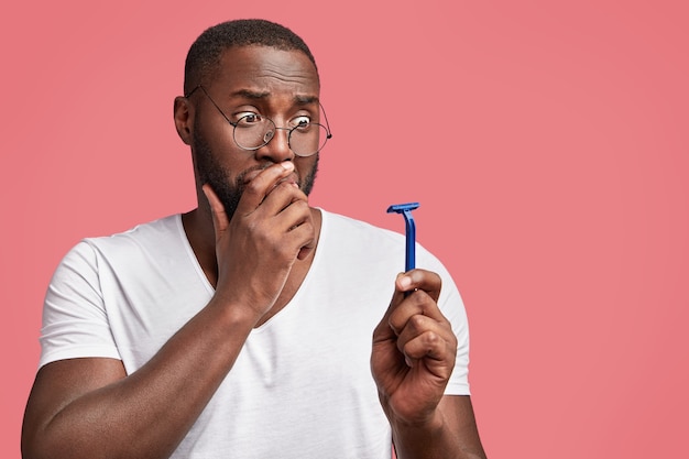 Young African-American man holding razor