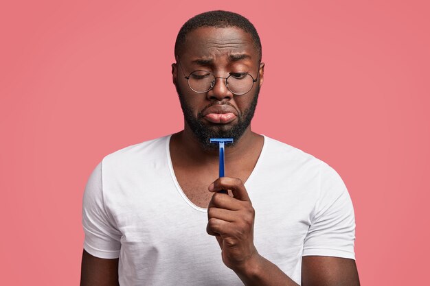 Young African-American man holding razor