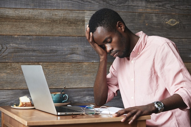 Young African-American man using laptop