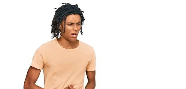 Free photo young african american man wearing casual clothes with hand on stomach because nausea, painful disease feeling unwell. ache concept.