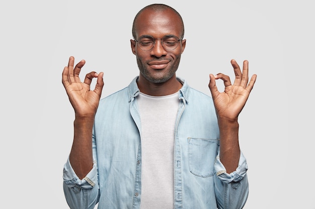 Young African American man wearing denim shirt
