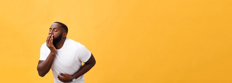Free Photo young african american man wearing white tshirt with hand on stomach because nausea painful disease