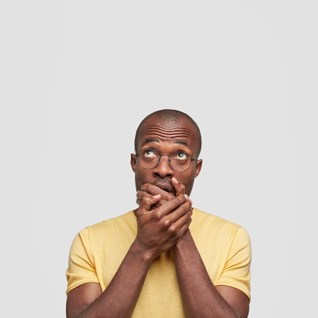 Young African American man wearing yellow T-shirt