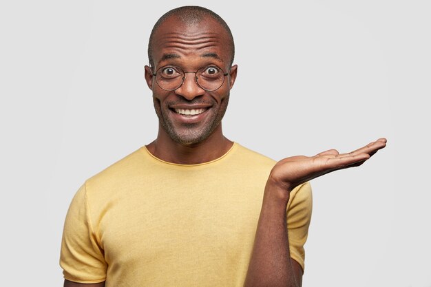 Young African American man wearing yellow T-shirt