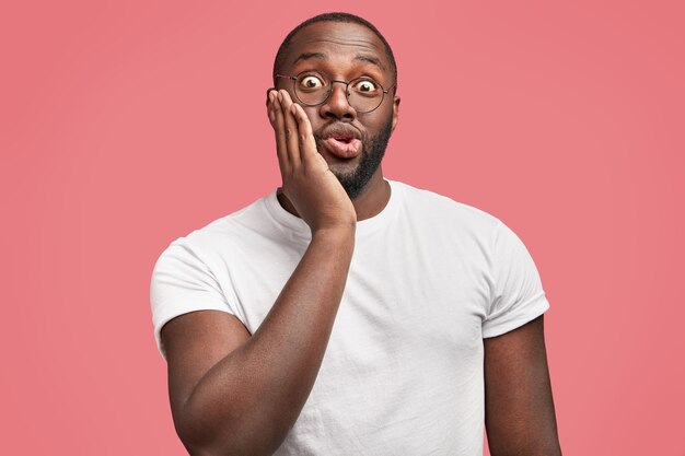 Young African-American man with round glasses