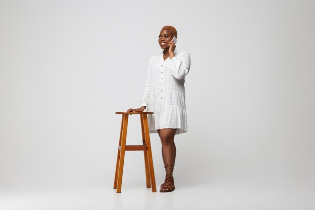 Young african-american woman in casual wear on gray