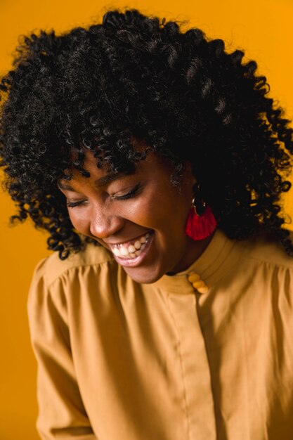 Young African American woman laughing with closed eyes