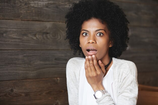 Young African-American woman sitting in cafe