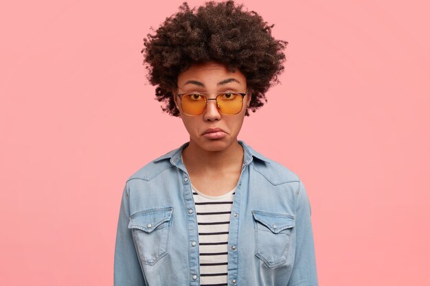 Young African-American woman wearing colored sunglasses