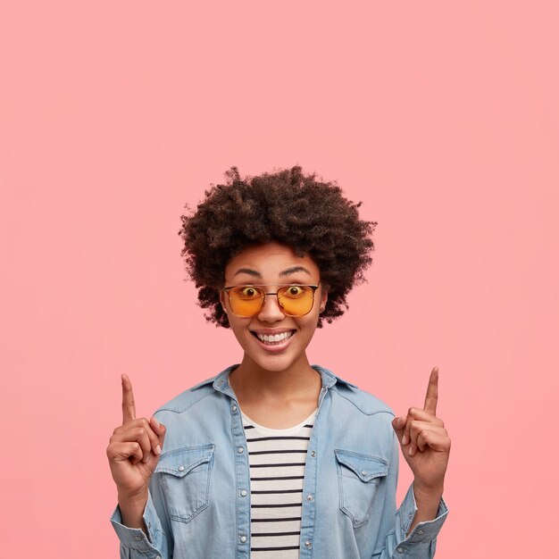 Young African-American woman wearing colored sunglasses