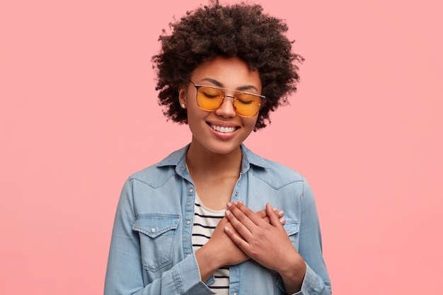 Young African-American woman wearing colored sunglasses