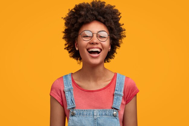 Young African-American woman wearing overalls