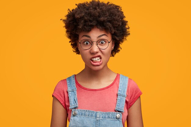 Young African-American woman wearing overalls