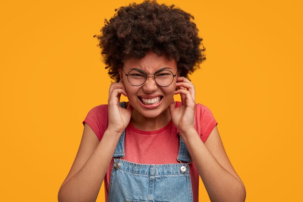 Young African-American woman wearing overalls