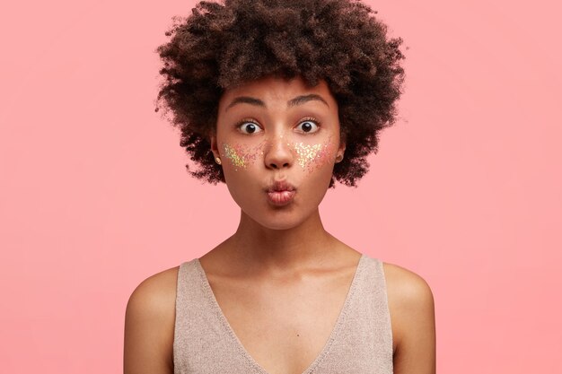 Young African-American woman with glitter on face