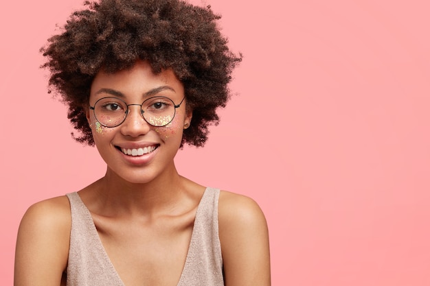 Free photo young african american woman with glitter on face