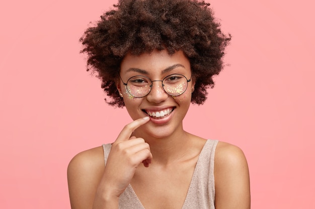 Young African American woman with glitter on face