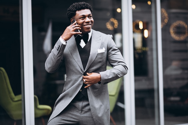 Young african businessman using phone