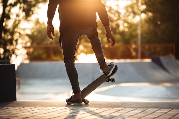 Young african man doing skateboarding outdoor