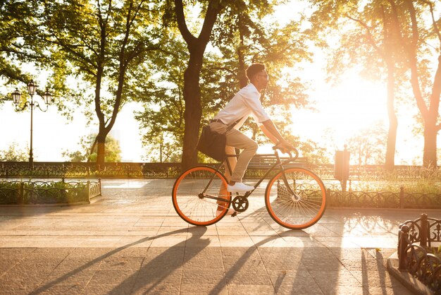 Young african man in early morning with bicycle walking