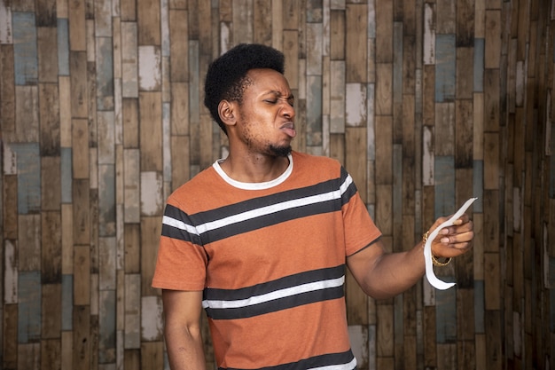 Young African man looking at a piece of paper