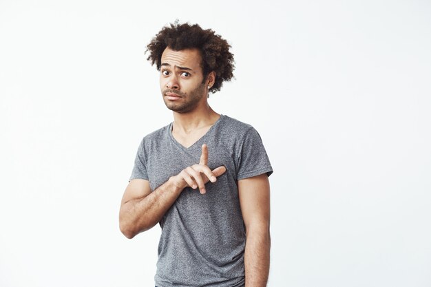 Young african man showing wait gesture.