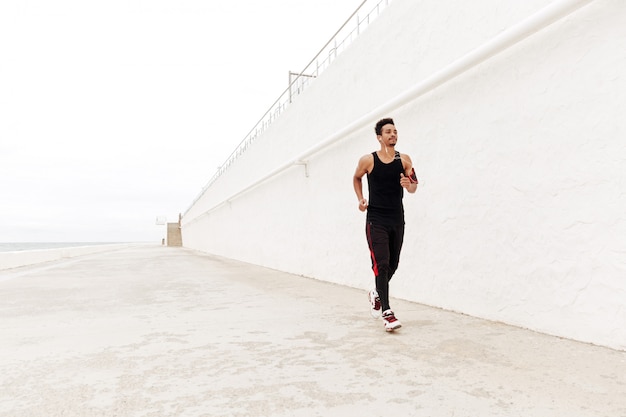 Free photo young african sports man running outdoors.