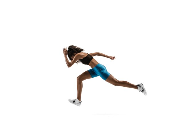 Young african woman running isolated on white studio background. One female runner or jogger. Silhouette of jogging athlete