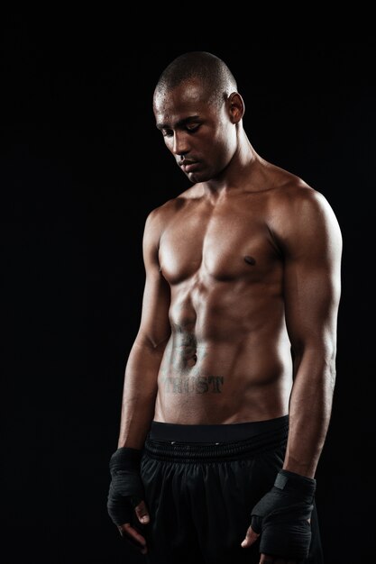 Young afro american boxer, looking down