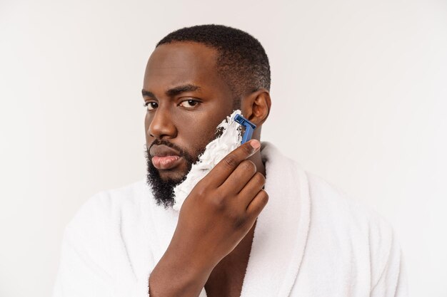 Young afro american man shaving in bathroom personal morning routine hygiene at morning concept