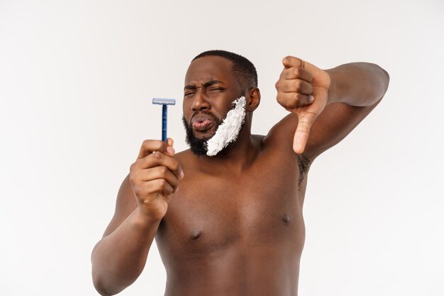 Young afro american man shaving in bathroom personal morning routine hygiene at morning concept