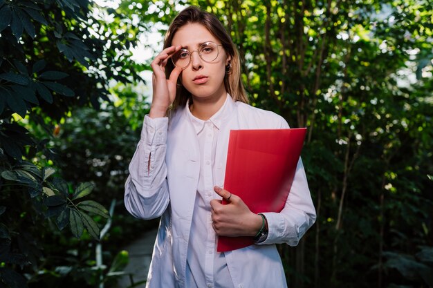 Young agricultural engineer working in greenhouse