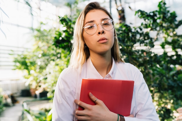 Young agricultural engineer working in greenhouse