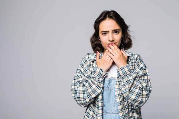 Young amazed woman covering her mouth with hand