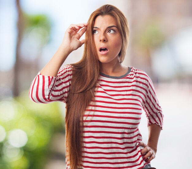 Young amazed woman thinking over.