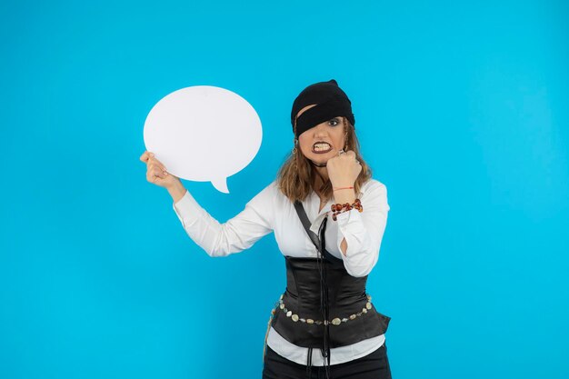 Young angry pirate girl holding white idea board. High quality photo