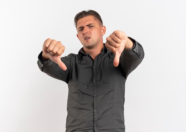 Free photo young annoyed blonde handsome man thumbs down isolated on white background with copy space