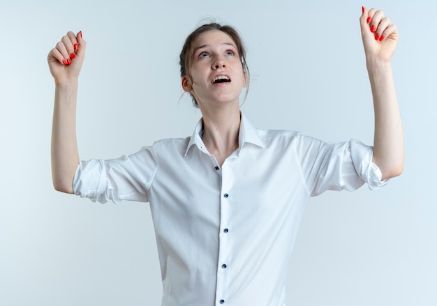 young anxious blonde russian girl looks and raises fists up