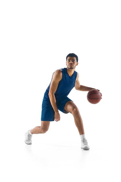 Young arabian muscular basketball player in action, motion isolated on white